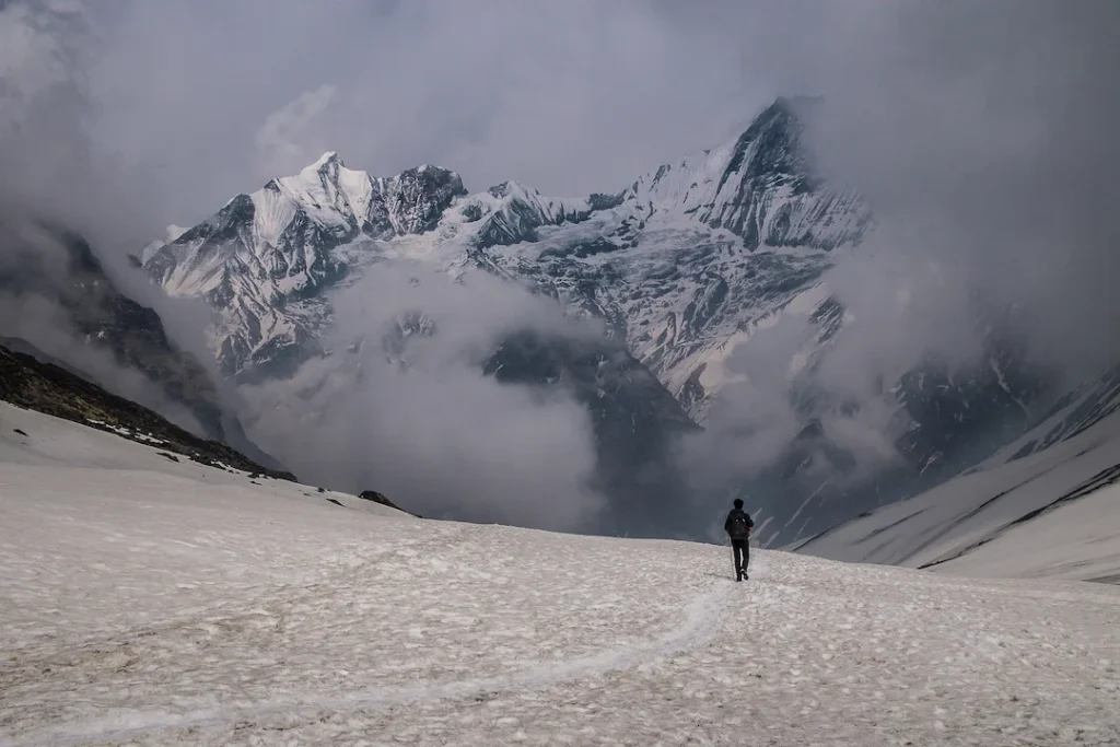 hiker-walking-snow-mountain