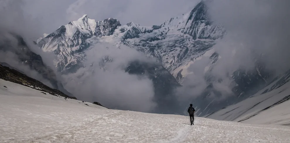 hiker walking snow mountain